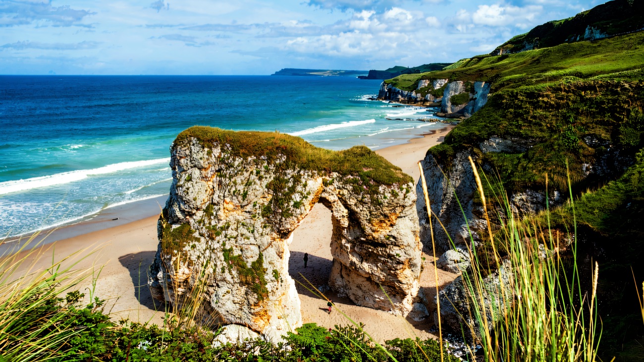 The famous Whiterocks limestone arch above the turquoise shallows