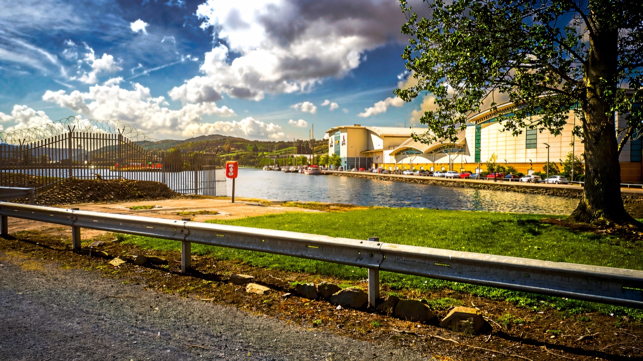 The Albert Basin and The Quays Shopping Centre seen from the leafy entrance to the Newry Greenway