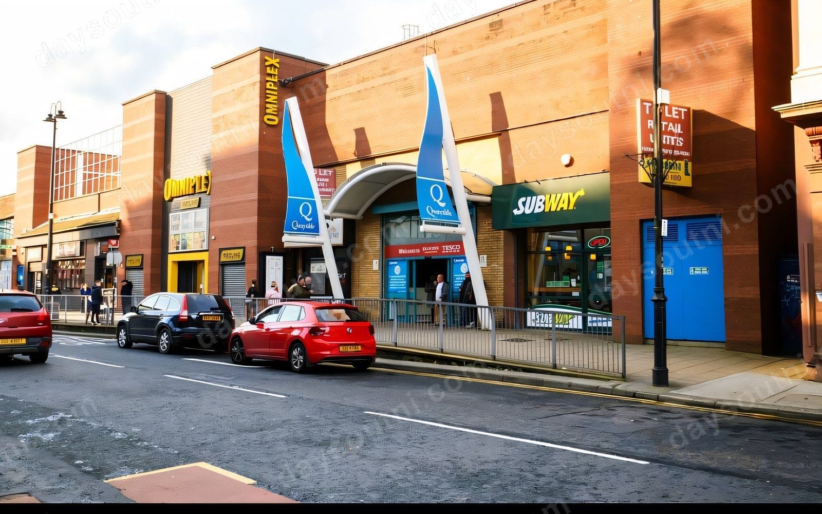 The Quayside Shopping Centre frontage on Strand Road, with the twin blue Quayside entrance sails, the Strand Omniplex cinema and a Subway alongside