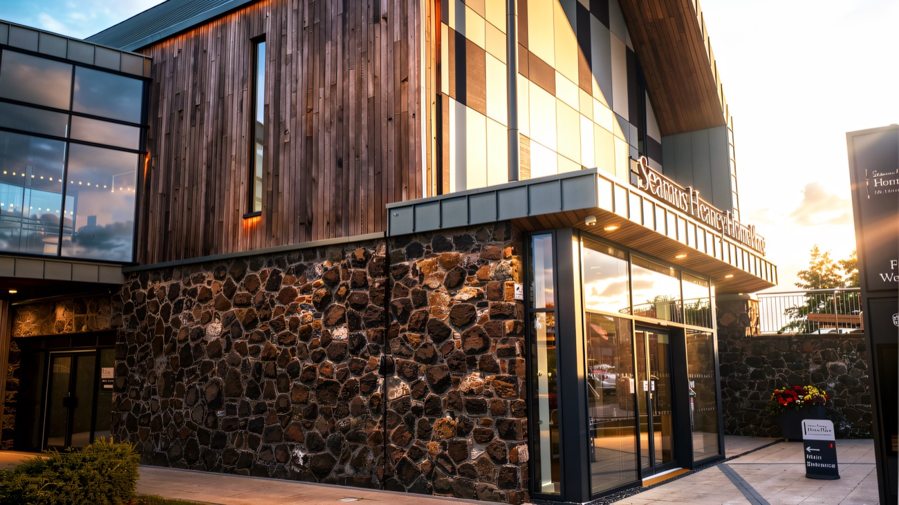 The entrance corner, where local basalt meets timber cladding.