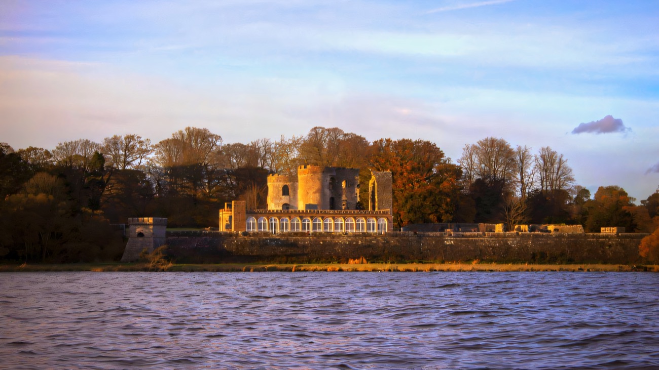 The castle ruins and Camellia House seen across Lough Neagh