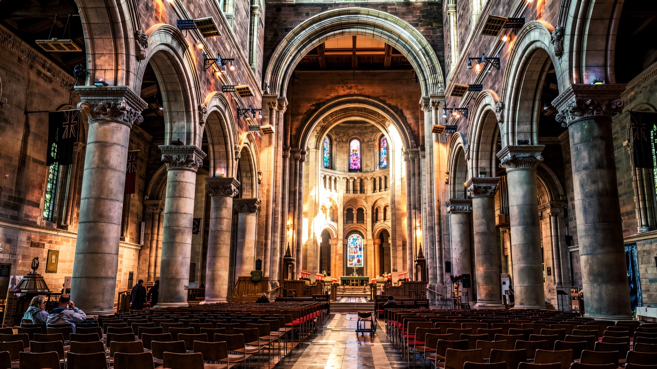 The great Romanesque arches drawing the eye toward the mosaic-lined apse.