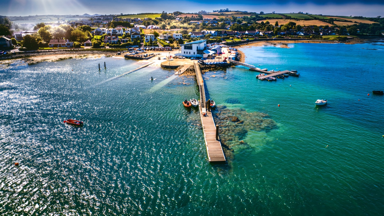 The clubhouse, pontoon and pier reaching out into the sparkling water