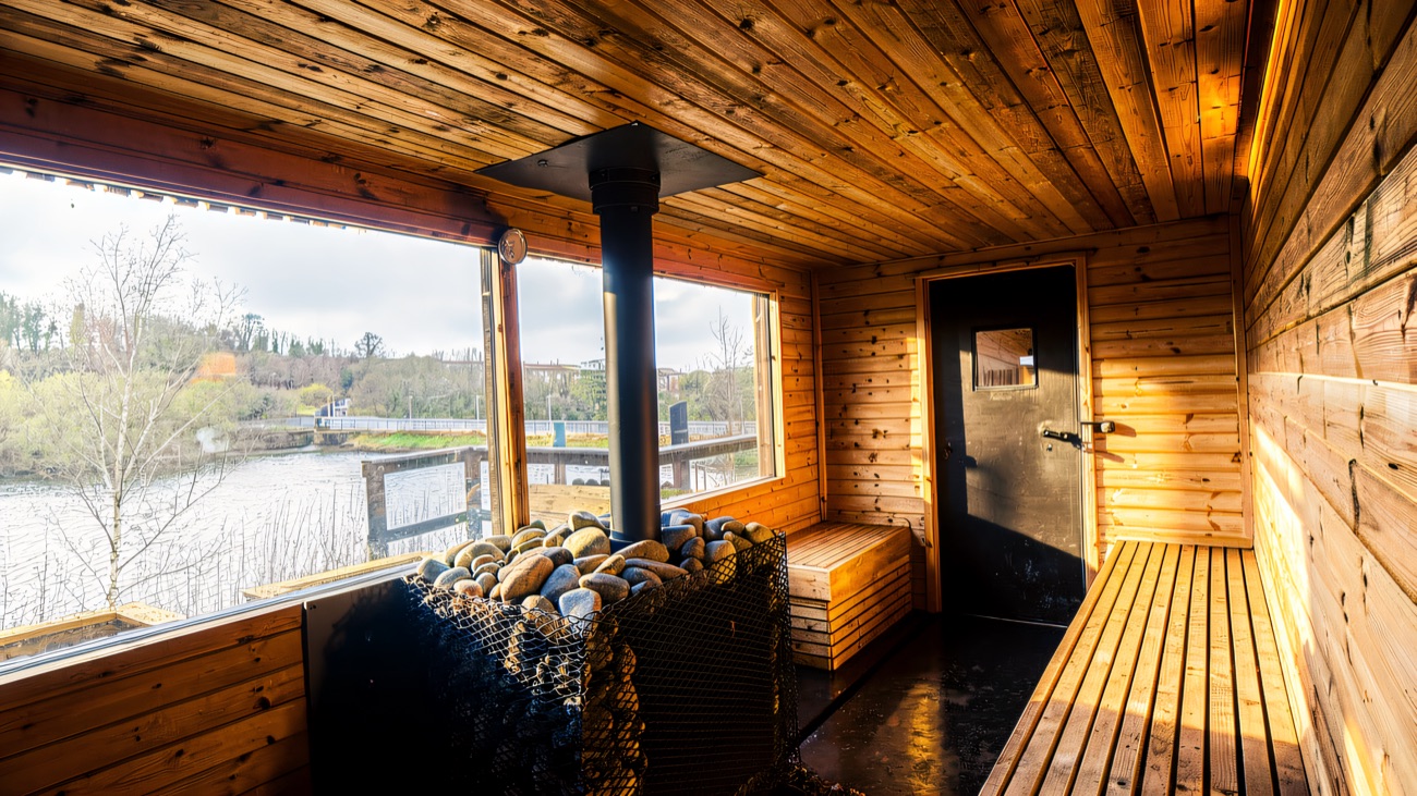 The sauna interior with a long window over the water