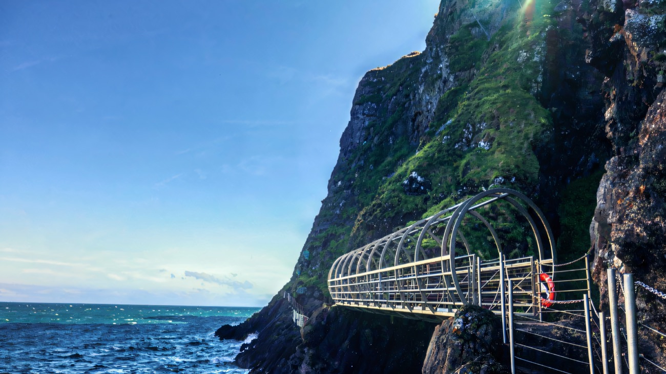 The Tubular Bridge reaching out over deep blue sea under a clear sky