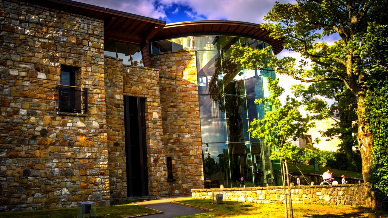 A side view where local stone meets the sweep of glass.