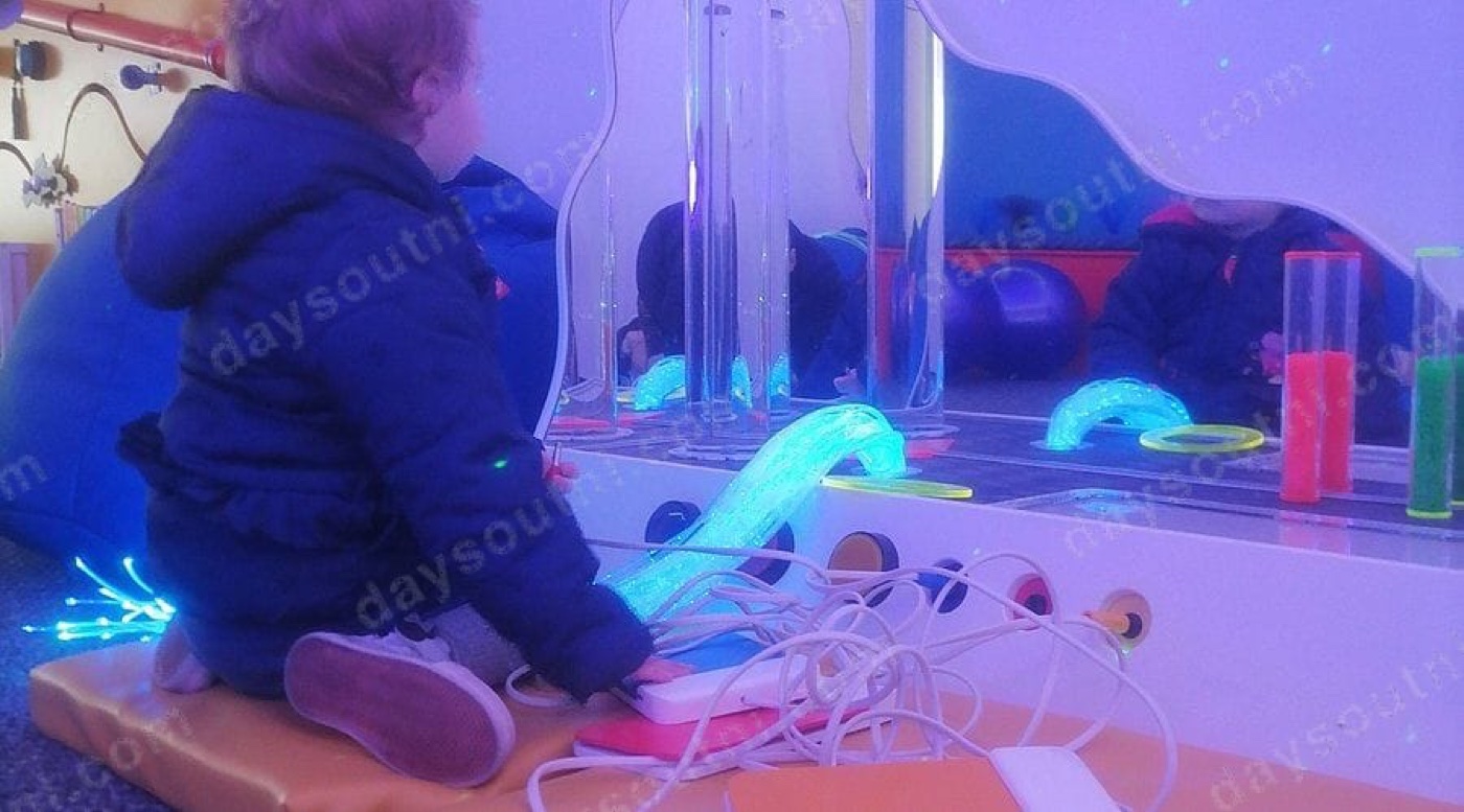The sensory room at Through the Looking Glass NI in Ballymoney, with glowing bubble tubes, fibre-optic lights and soft seating in a calm, dimly-lit space