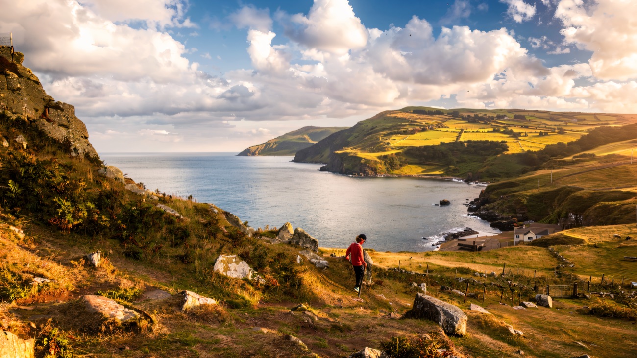 A walker heading down the path toward the cove and the viewpoint