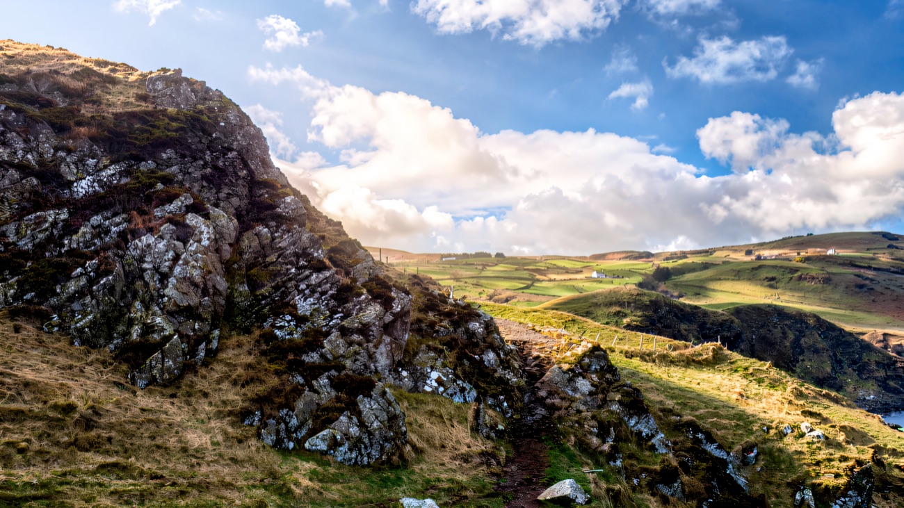 The rugged path over rock and heather along the headland