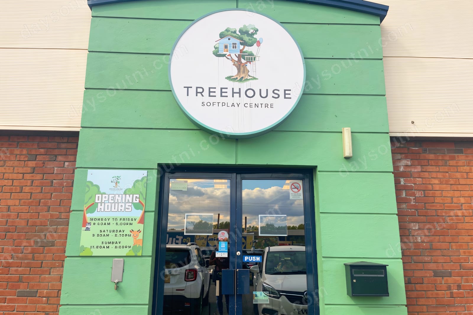 The green shopfront of Treehouse Softplay Centre in Lurgan, with its treehouse logo and an opening-hours poster