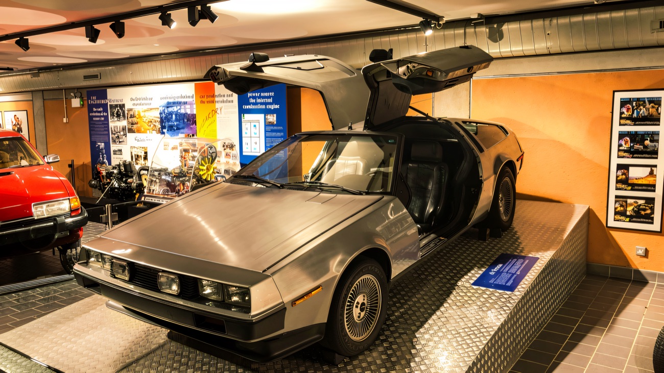The silver DeLorean sports car with its gullwing doors raised, on display in the Transport Museum