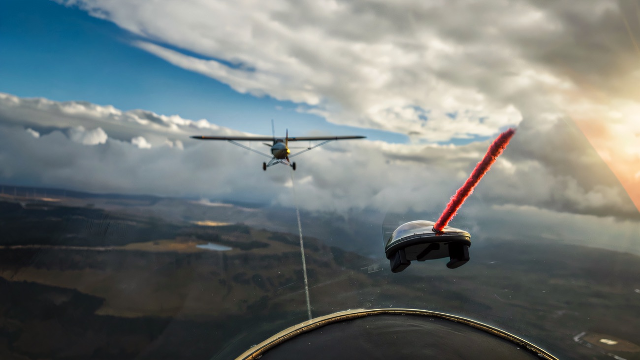 The view from the glider cockpit on aerotow, following the tug plane over the fields below