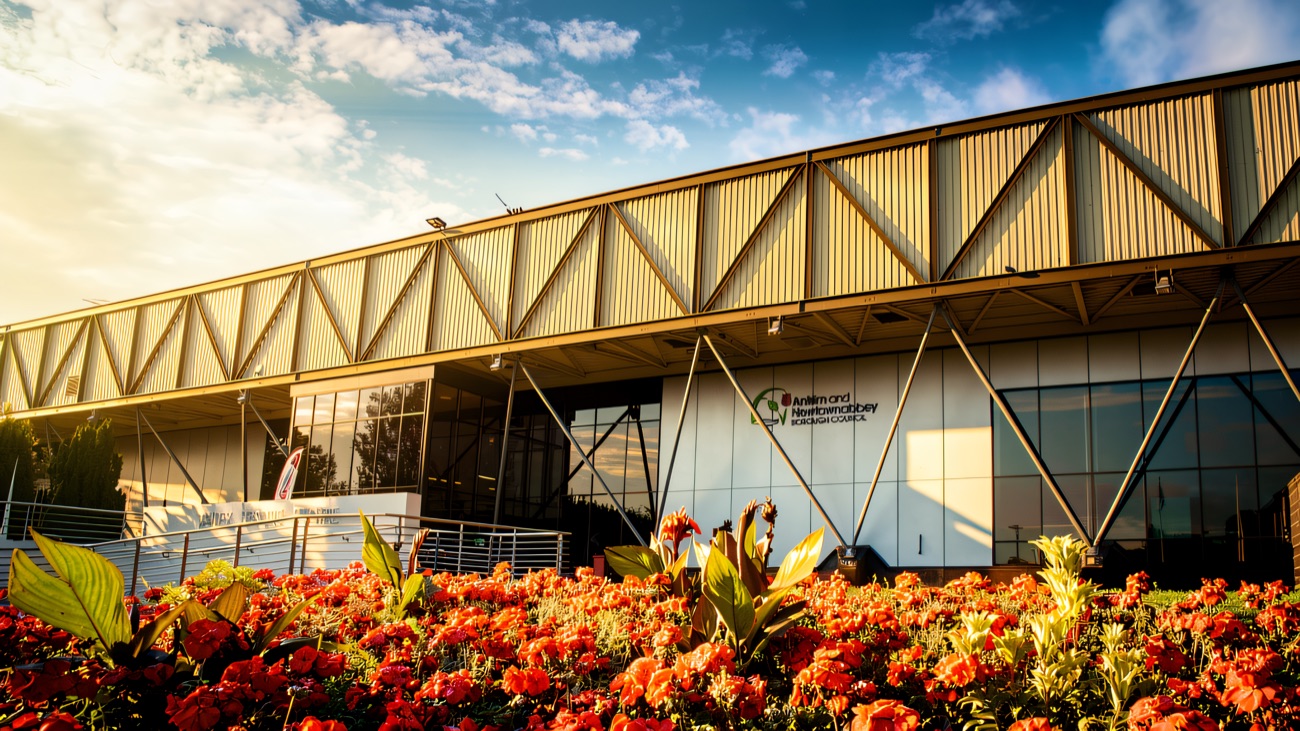 The centre's long glass and steel frontage behind a bed of bright red flowers