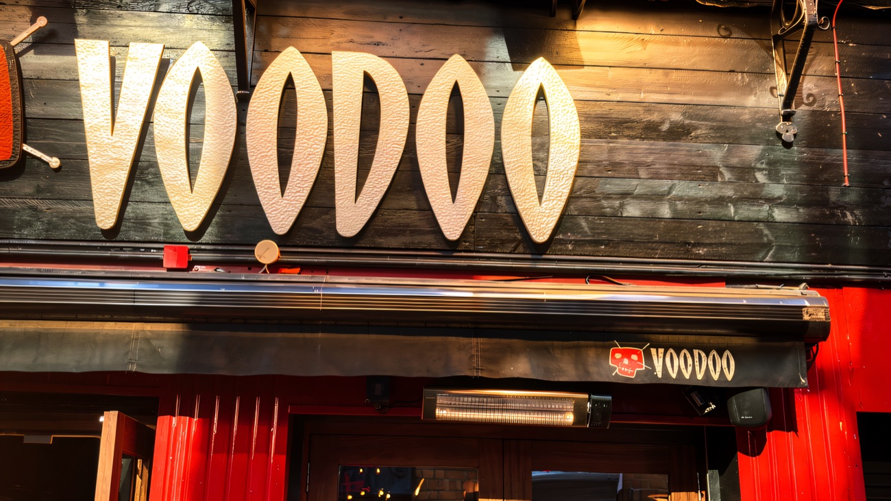 The Voodoo sign above the entrance, with flower baskets on the balcony